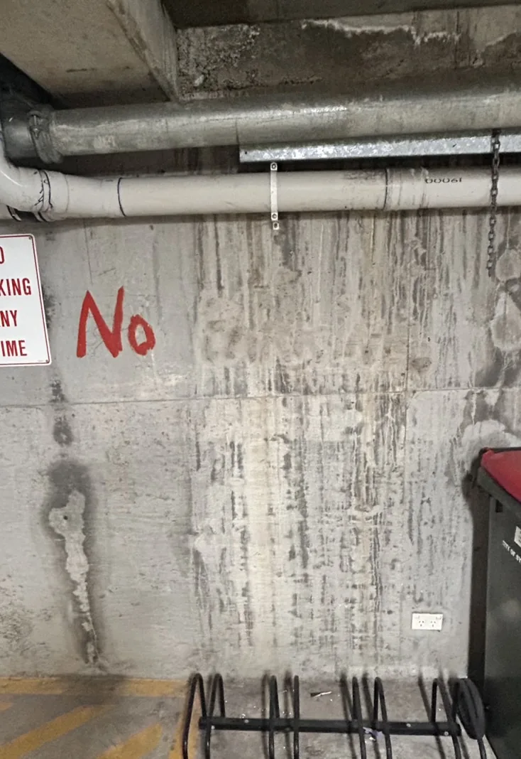 Laser graffiti removal result on sandstone surface — before and after